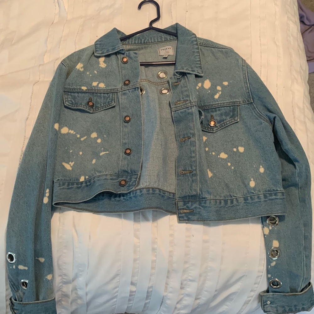 Trendy, vintage bleached jean jacket with grommets